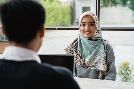 veiled women interviewed as new employees by the owner of the companyの写真素材
