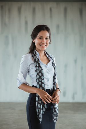 asian woman worker standing smile with scarfの写真素材