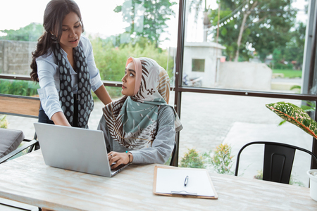 woman boss gives direction to his employees with patient about company financialの写真素材