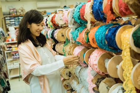 asian woman shopping some fabric decorationの写真素材