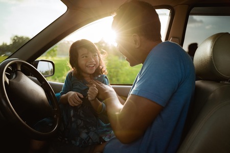 father daughter playing in the car togetherの写真素材
