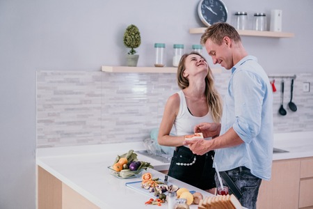 Romantic couple smiling taste foodの写真素材