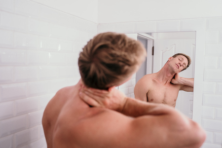 Handsome athletic men shirtless at front reflection the mirrorの写真素材