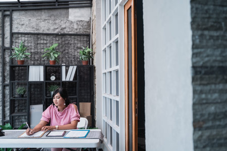 female worker in her office working on paperwork