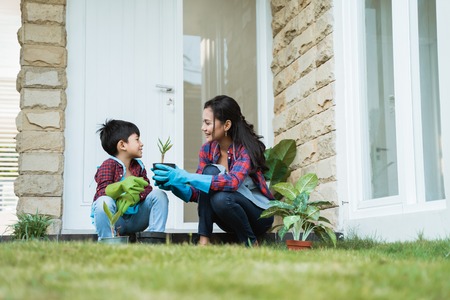 mom and son planting new plant. gardening activityの写真素材
