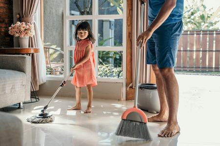 little girl help her daddy to do choresの写真素材