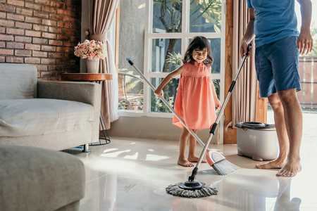 father and daughter clean up the houseの写真素材