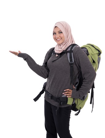 smiling asian woman backpacker presenting copyspaceの写真素材