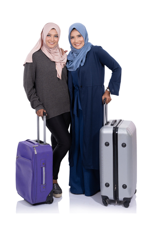 smiling asian woman hijab with suitccaseの写真素材