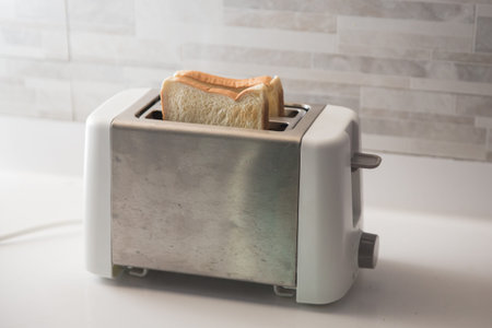 bread on toaster in the kitchen
