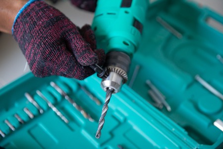 worker with hands glove prepare drillの写真素材