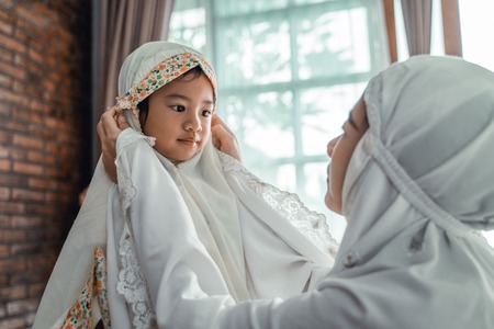 muslim mother and child with scarf to prayの写真素材