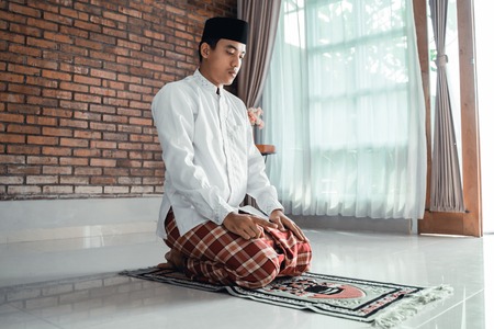 muslim asian man praying to godの写真素材
