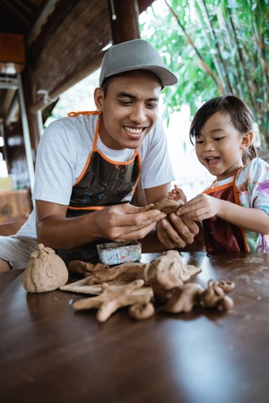 Child working with clay making potteryの写真素材