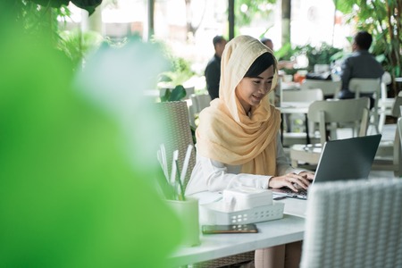 woman with hijab working using laptopの写真素材