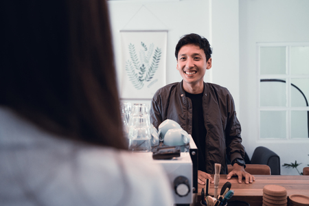 asian customer ordering coffee to baristaの写真素材