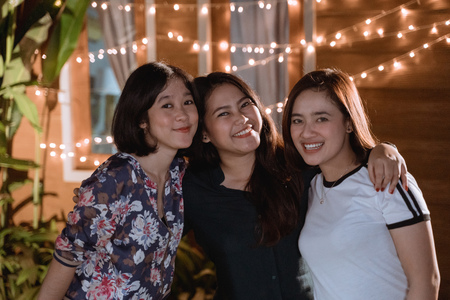 asian beautiful female friend in backyard partyの写真素材