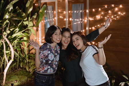 asian beautiful female friend in backyard partyの写真素材