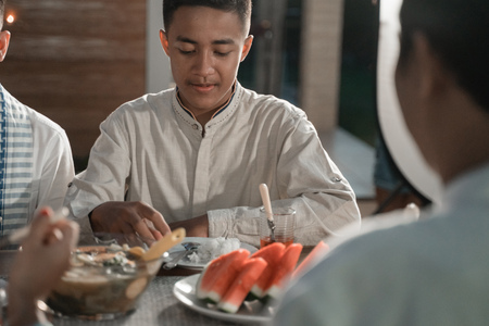 friends gathering  enjoy the iftar meal in the backyard houseの写真素材