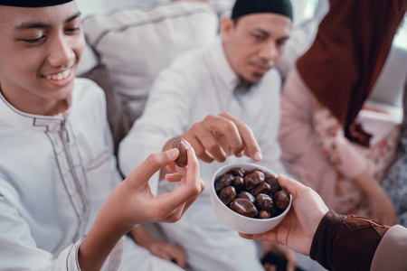 muslim people taking dates fruit for breaking fastの写真素材