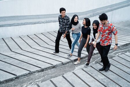 friends having fun outdoors walking on the way togetherの写真素材