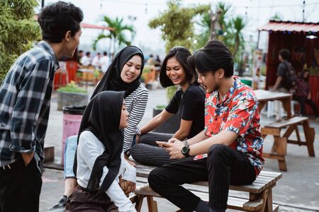 portrait of young people joking together when hanging outの写真素材