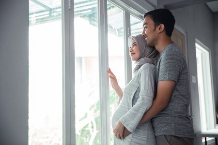 holding on husband and wife pregnant bellyの写真素材