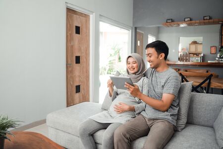 couple looking at tab screen imagesの写真素材