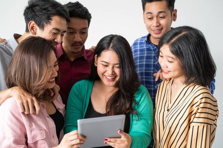 woman and her friend hold the tabletの写真素材