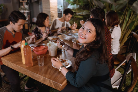 smiling asian woman enjoying their garden dinner partyの写真素材
