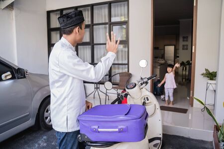 muslim male travelling for eid mubarak by motorcycleの写真素材