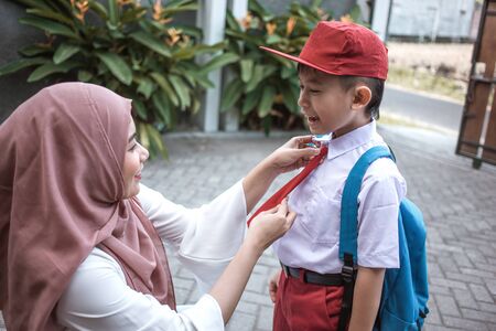 mom help her son preparing for schoolの写真素材