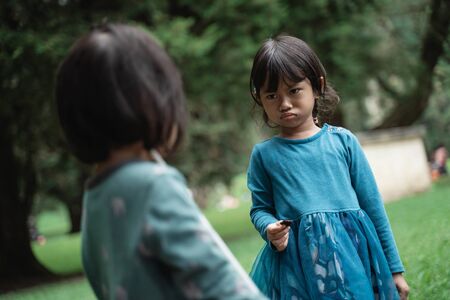 two little girls fighting over toysの写真素材