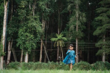 little daughter having fun aloneの写真素材
