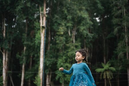 little daughter having fun aloneの写真素材