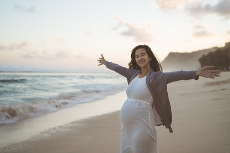 mother stands with her arms outstretched