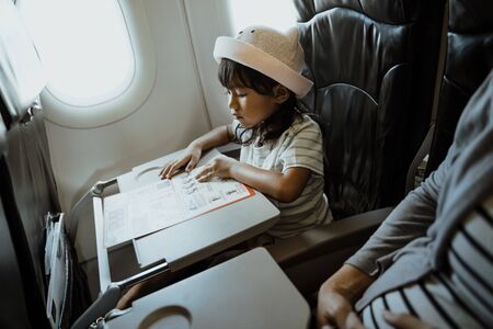 Asian little girls are busy readingの写真素材