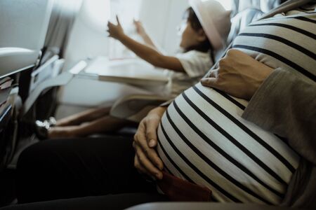 Asian pregnant women enjoy traveling by airplaneの写真素材