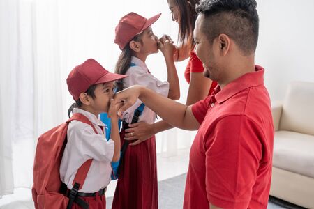 student kiss his parents hand before going to schoolの写真素材
