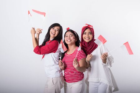indonesian woman with flag celebrating independence dayの写真素材