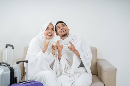 wife and husband in white traditional clothes for Ihramの写真素材