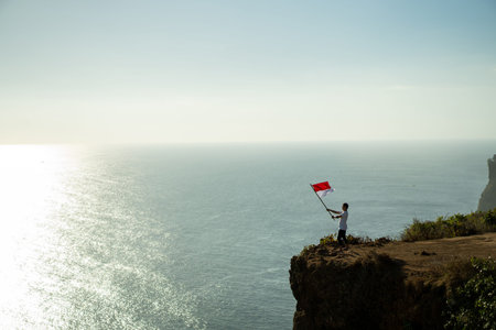 asian male with indonesian flag celebrating independence day