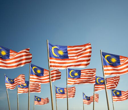 malaysia flag under blue skyの写真素材