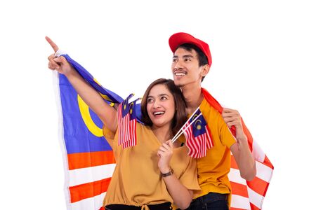 asian woman pointing while hold national flagの写真素材