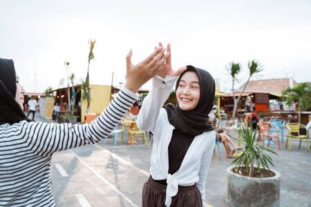 young hijab woman high five with friendsの写真素材
