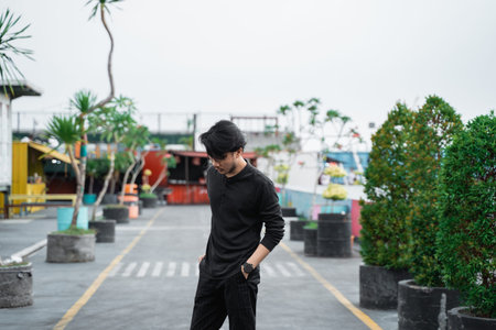 asian young man standing on the way