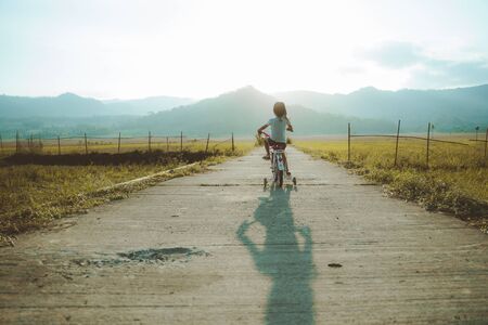 Toddler enjoy riding her bicycle outdoorの写真素材