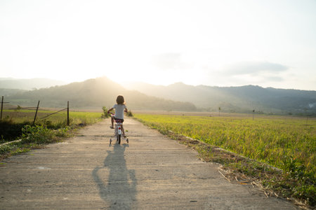 Toddler enjoy riding her bicycle outdoorの写真素材
