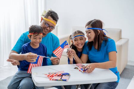 Family creating malaysia flag for independence dayの写真素材