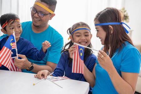 Family creating malaysia flag for independence dayの写真素材
